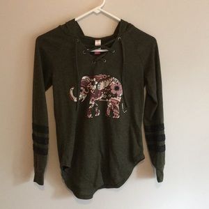 A green long sleeve shirt with a hoodie